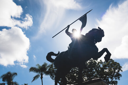 statue of warrior on horse, silhouette with sunspot