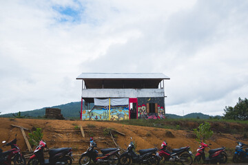 shed structure with graffiti and mopeds in asia