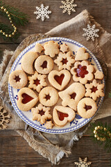 A plate of homemade Linzer Christmas cookies filled with marmalade and dusted with sugar
