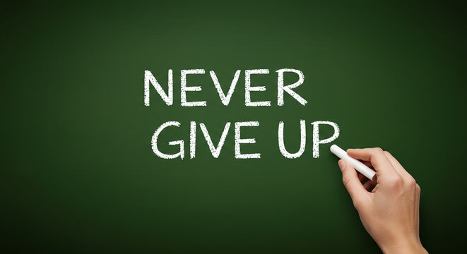 Hand writing motivational phrase "Never Give Up" on green chalkboard. - Powered by Adobe