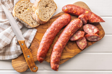 Sliced smoked ​​sausage on cutting board. Top view.