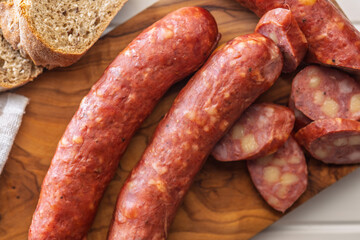 Sliced smoked ​​sausage on cutting board. Top view.