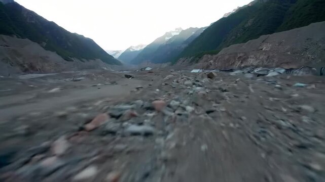 Glacier moraine and mountain valley, forward motion drone shot