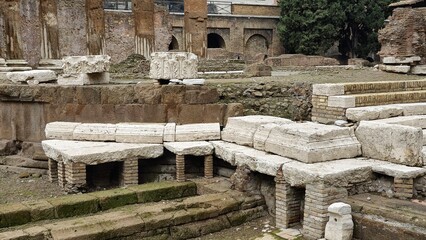Rome, Italy - 11 January 2025. Fragmented column tops and stacked Roman masonry stand at the Curia...