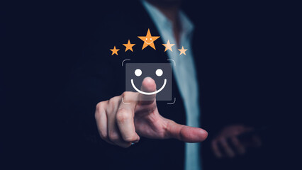 Businessman touching happy smile face icon on digital screen, concept of online technology for customer satisfaction survey, feedback, and quality service improvement.