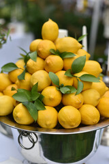 A mountain of lemons in a bowl