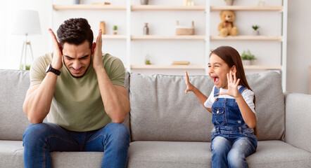 Problems Of Parenthood Concept. Portrait of angry naughty girl screaming loud and shouting at her...