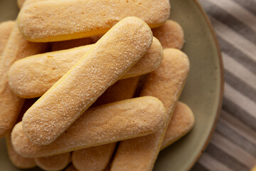 Savoiardi biscuits on a plate, top view. Close-up.