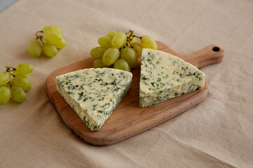 Delicious Cheese Danablu on a wooden board, side view.