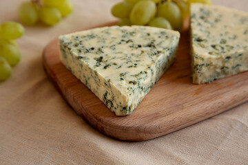 Delicious Cheese Danablu on a wooden board, side view.
