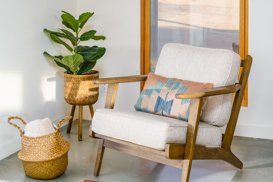 Modern accent lounge chair wood frame, southwest pillow in desert home