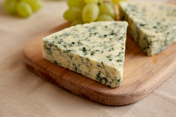 Delicious Cheese Danablu on a wooden board, side view.