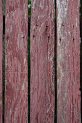 Closeup of painted weathered wooden planks of old fence background