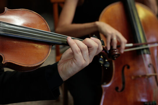 musicians playing violin and cello at a music concert