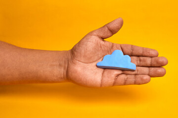 Hand holding a cloud icon representing cloud computing data storage and scalable digital services enabling mobility collaboration and innovation.
