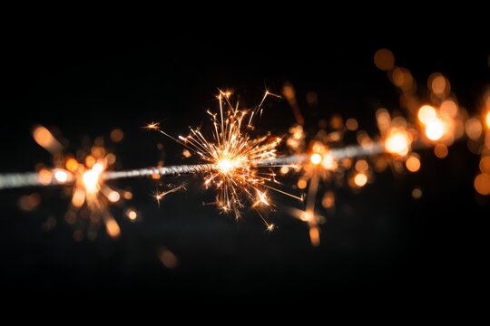 Close-up shot of a sparkler with bright sparks in front of a dark background, creating a festive and magical atmosphere, celebration and holiday spirit conveyed. - Powered by Adobe