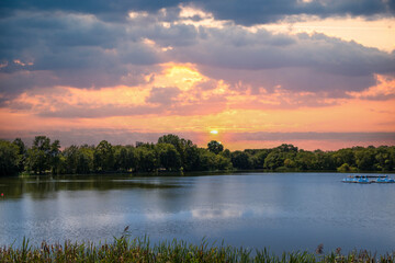 A lake surrounded by lush green trees and grass at FDR Park in Philadelphia Pennsylvania USA