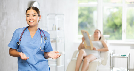 Obraz premium Advertising banner of cosmetology office clinic. Doctor in medical uniform. Private outpatient practice. Individual approach to treatment. Patient in background