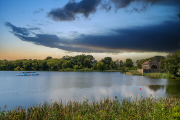 A lake surrounded by lush green trees and grass at FDR Park in Philadelphia Pennsylvania USA