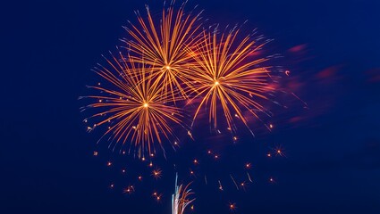 Fototapeta premium Golden Fireworks against deep blue night celebration background