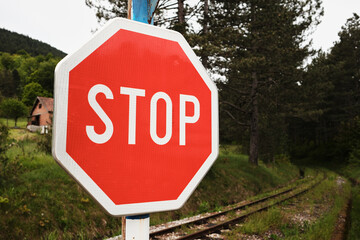 Close-up of a red STOP sign at railway crossing in Mokra Gora, Serbia