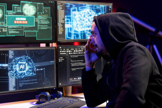 Hacker sad after seeing access denied popup on PC, trying to breach company systems using deep learning. Rogue engineer frowns, getting rejected when trying to infiltrate enterprise networks using AI
