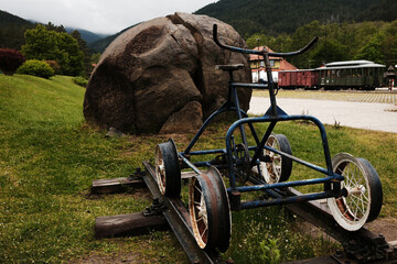 Old blue rail bike on display at Mokra Gora station in Serbia, surrounded by green grass in spring. Shargan - Sargan railway station
