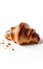Single golden-brown croissant, crumbs
