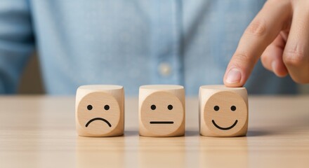 Customer choosing a smiling face icon on a wooden cube for a positive satisfaction rating and service experience survey