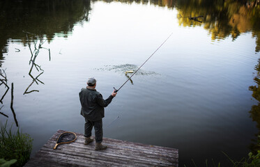 Fisherman and trophy Pike. Fishing background. 