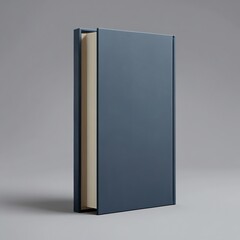 A closed blue book stands upright on a gray surface