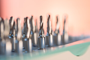 Full set of dental implant drill bits in surgical tray, close-up of professional dentistry equipment