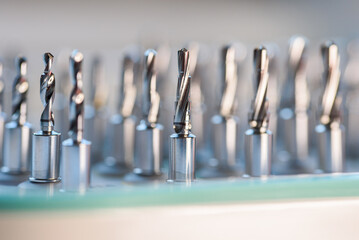 Full set of dental implant drill bits in surgical tray, close-up of professional dentistry equipment