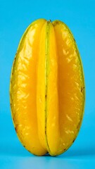 Yellow Starfruit with Unique Shape and Juicy Texture Isolated on Blue Background for Exotic Tropical Fruit Object and Healthy Food Concept
