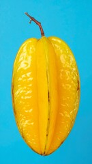 Yellow Starfruit with Unique Shape and Juicy Texture Isolated on Blue Background for Exotic Tropical Fruit Object and Healthy Food Concept