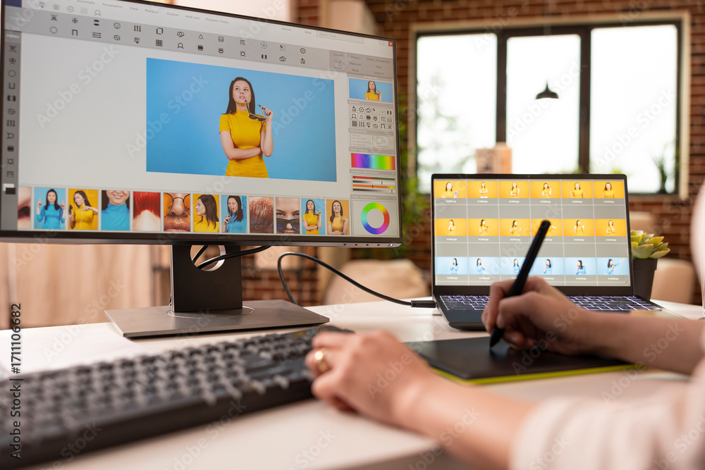 Poster closeup of photographer using stylus on touchscreen tablet for retouching image tones and compositio