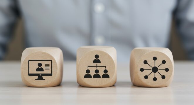 Wooden blocks with icons representing business concepts remote work, team hierarchy, and network connections