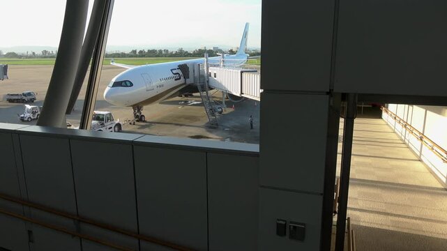 The Starlux A330 and a passenger boarding bridge on the apron in Sendai, 2025.09.16.