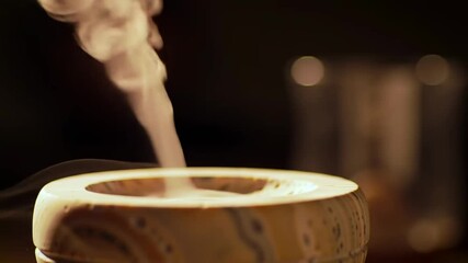 Elegant stone aroma diffuser releasing fragrant mist, creating a serene atmosphere for wellness and relaxation