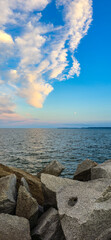 Baltic Sea Rocky Shoreline with Cloudy Sky and moon sunset
