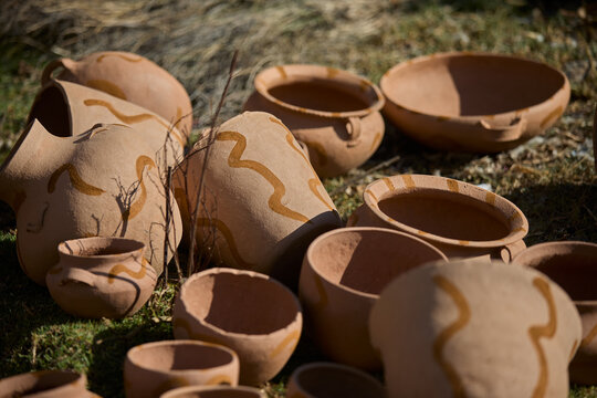 skillful hands bring life to the clay, tracing simple yet symbolic patterns onto the ollas de barro of Huancas. Each mark is a gesture of heritage, preserving centuries of artistry before the fire.