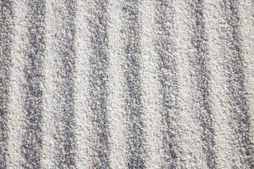 Sand patterns. Patterns formed on small white stone chips. Landscape design background.