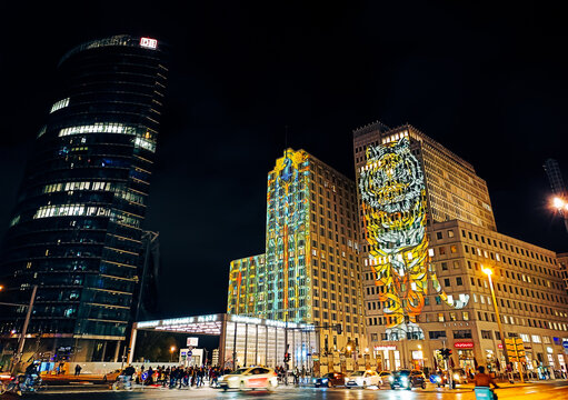 Berlin, Germany - October 10, 2024: Majestic tiger sits atop the P5 building, as if watching over the Potsdamer Platz. Artwork by Otto Schade, one of the highlights of Festival of Lights 2024