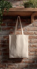 Simple beige tote bag hanging on a brick wall with wooden shelf.