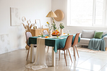 Beautiful table setting with citrus fruits and candles in living room