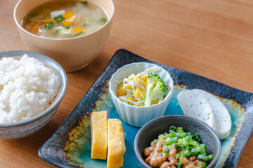 Traditional Japanese breakfast with rice miso soup natto and side dishes
