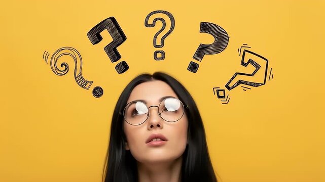 Young female student with glasses and question icons on yellow background	