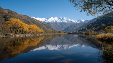 Fototapeta premium Serene Mountain Lake with Golden Autumn Trees and Snowy Peak Reflections - Nature Landscape for Travel Promotion and Scenic Wall Art