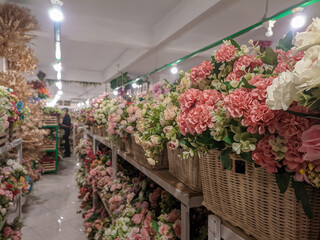 Various types of artificial flowers in various colors for decorative display on store shelves, concepts of variation and diversity. 