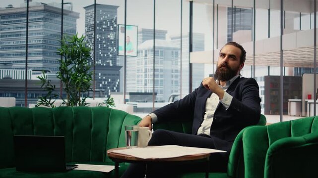 Male entrepreneur studying investments on a hologram illustration, using holography technology for productivity in smart office corporation. Boss looks at holographic image. Camera A.